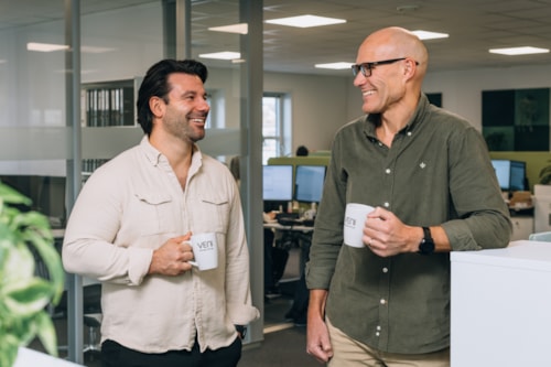 Two people holding coffeecups